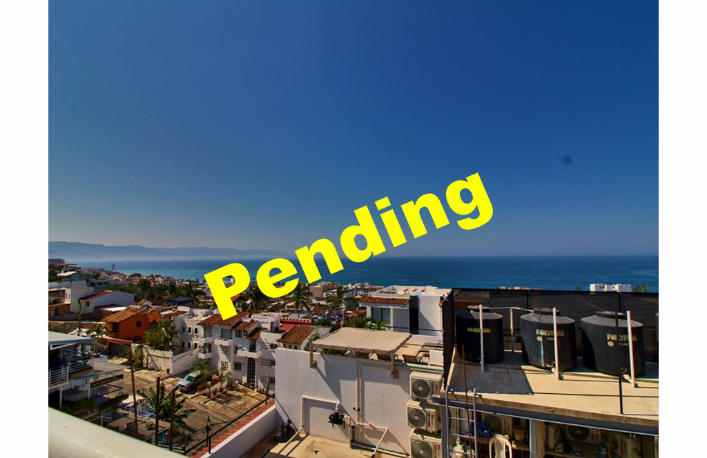 Ocean view from building roof top with PENDING text written across