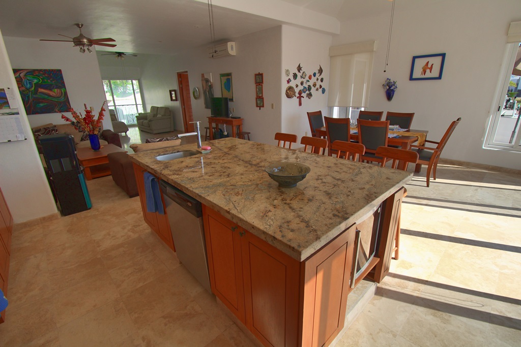 Brown color granite counter top on kitchen island with sink and dishwasher.